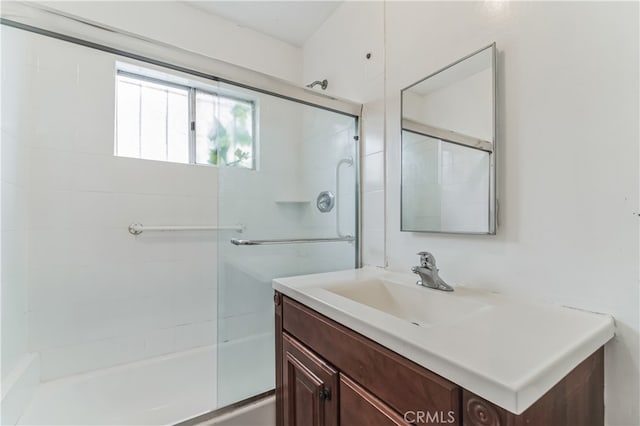 bathroom with enclosed tub / shower combo and vanity