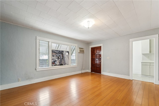 spare room with wood-type flooring and a wall mounted AC