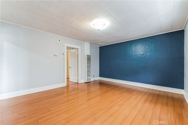 spare room with wood-type flooring and ornamental molding