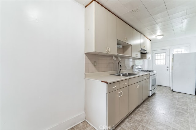 kitchen with sink, white appliances, and decorative backsplash