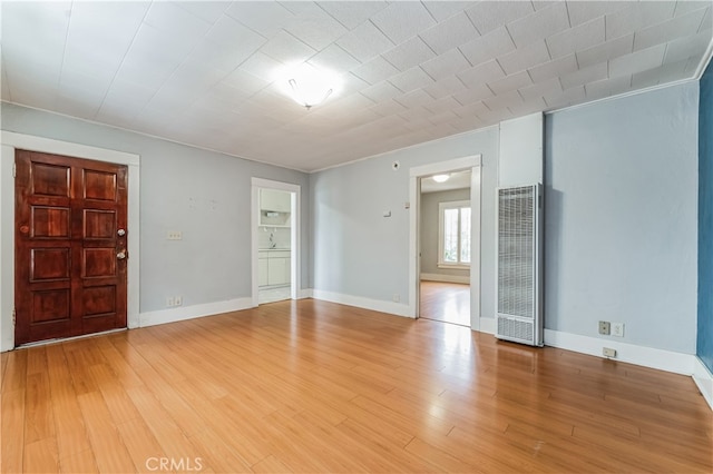 interior space featuring hardwood / wood-style floors and crown molding