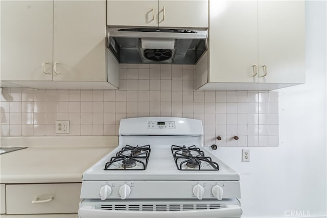 kitchen featuring range hood, white gas range, and tasteful backsplash