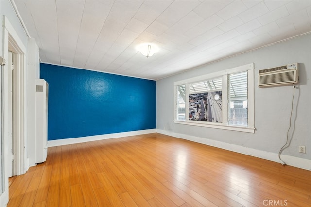 spare room featuring crown molding and hardwood / wood-style floors