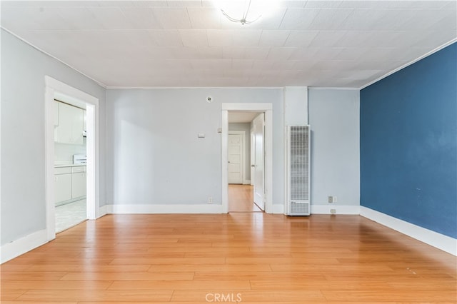 unfurnished room with hardwood / wood-style flooring and crown molding