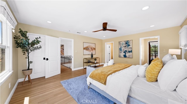 bedroom with ceiling fan, light hardwood / wood-style flooring, and access to exterior