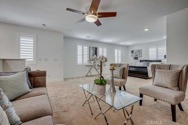 living room featuring light carpet and ceiling fan