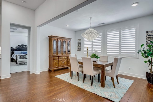 dining room featuring dark hardwood / wood-style floors and a chandelier