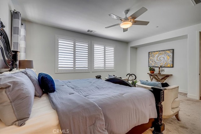 bedroom with ceiling fan and light carpet