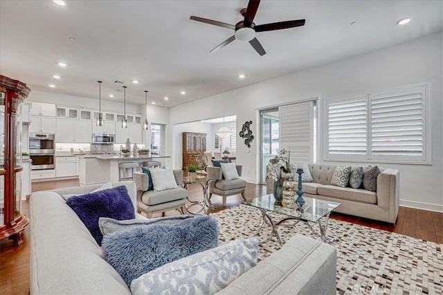 living room with ceiling fan, hardwood / wood-style floors, and a wealth of natural light