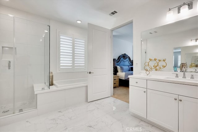 bathroom with independent shower and bath and vanity