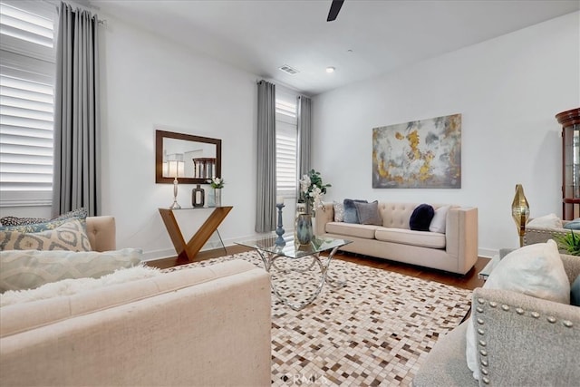 living room with wood-type flooring, ceiling fan, and plenty of natural light