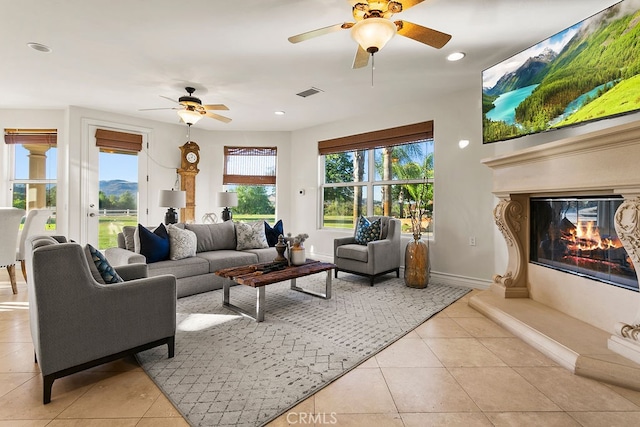 tiled living room with ceiling fan