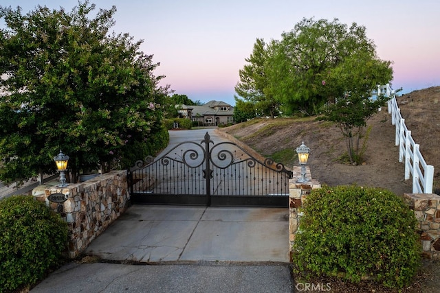 view of gate at dusk