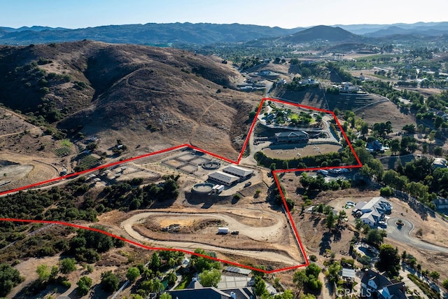 birds eye view of property with a mountain view