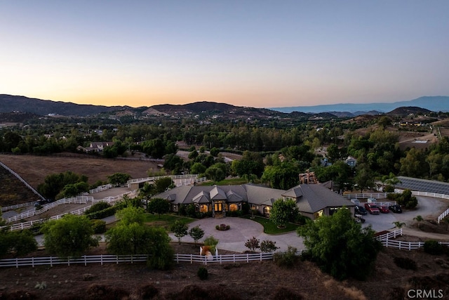 aerial view at dusk featuring a mountain view