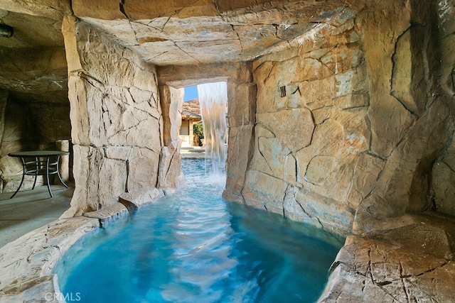 view of pool featuring pool water feature