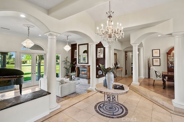 interior space featuring french doors, crown molding, a notable chandelier, and light tile patterned floors