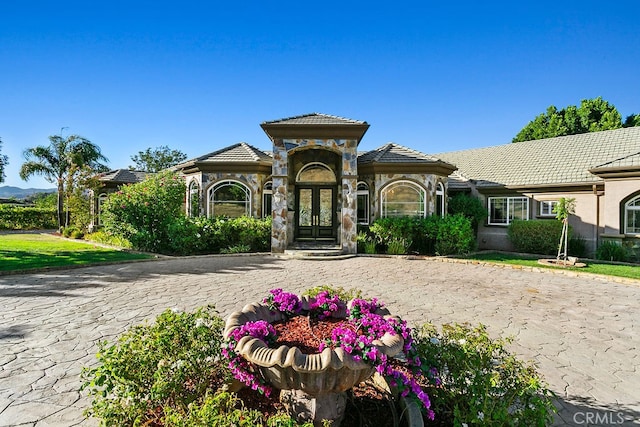 mediterranean / spanish-style home featuring french doors