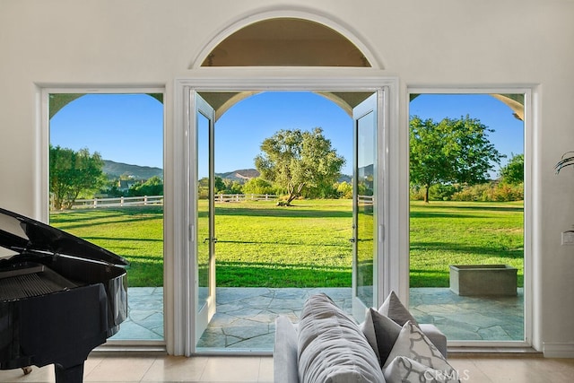 entryway with light tile patterned flooring and a mountain view