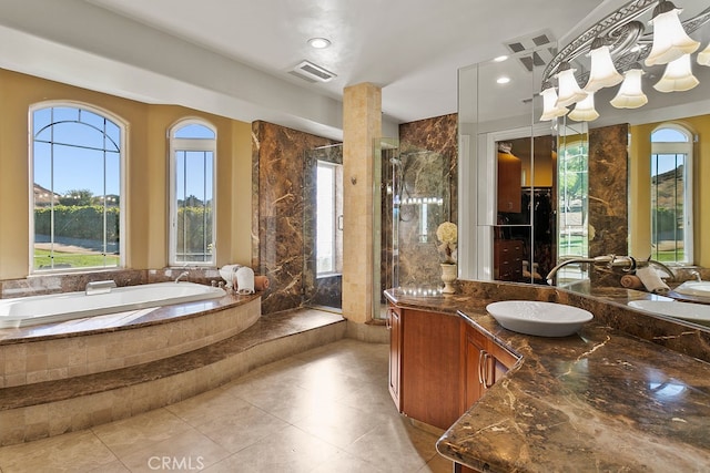 bathroom with vanity, independent shower and bath, and tile patterned flooring