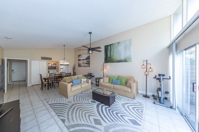 living area with high vaulted ceiling, visible vents, a textured ceiling, and light tile patterned flooring