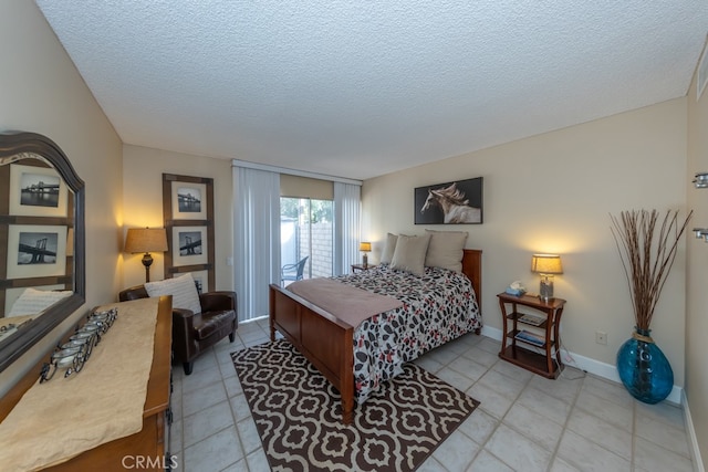 bedroom featuring access to outside, a textured ceiling, baseboards, and light tile patterned floors