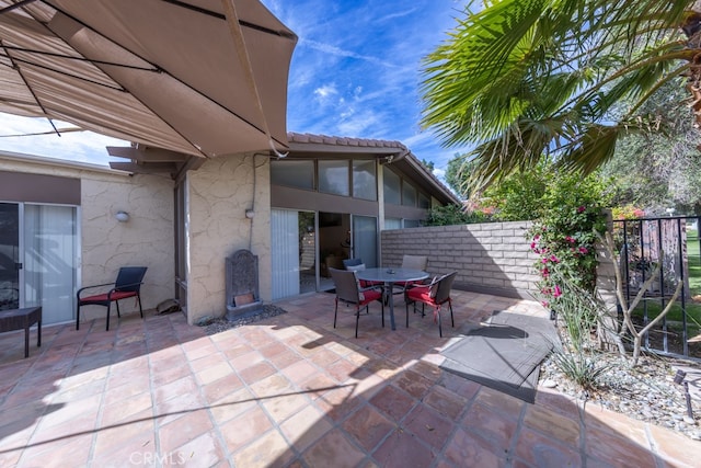 view of patio / terrace featuring fence and outdoor dining space