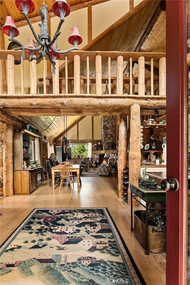 interior space with wood ceiling, high vaulted ceiling, beam ceiling, and hardwood / wood-style floors