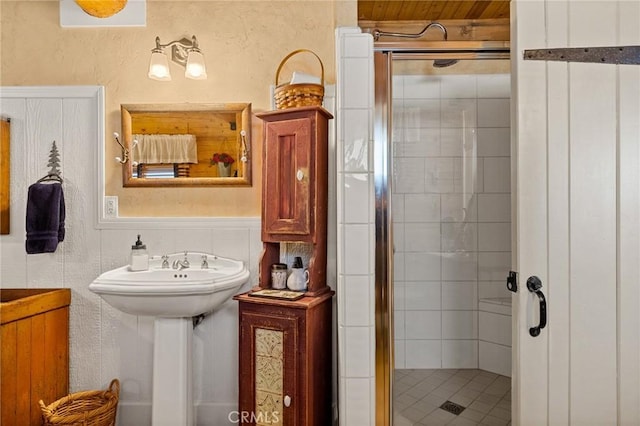 bathroom with a shower with shower door