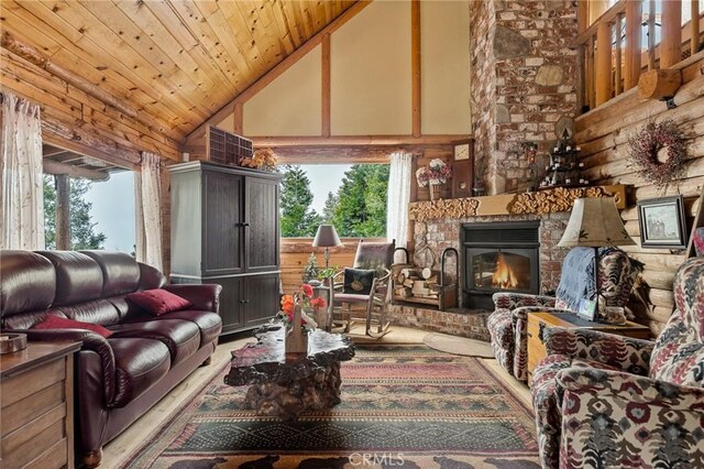 living room featuring wood ceiling, a fireplace, high vaulted ceiling, and a healthy amount of sunlight