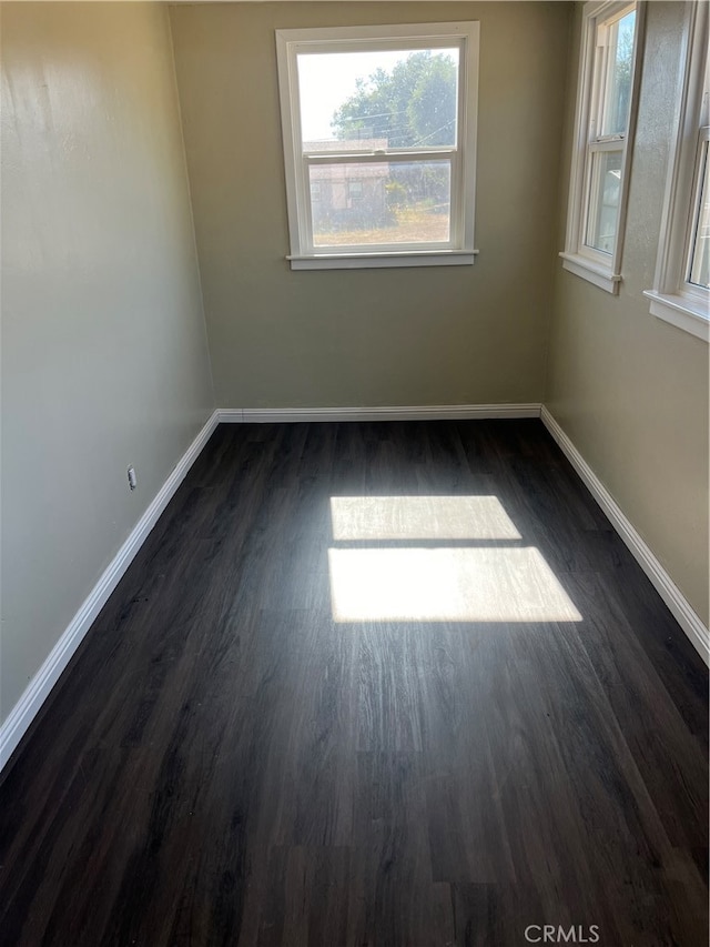 spare room with dark hardwood / wood-style flooring