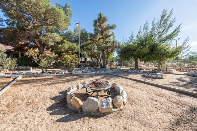 view of yard with an outdoor fire pit