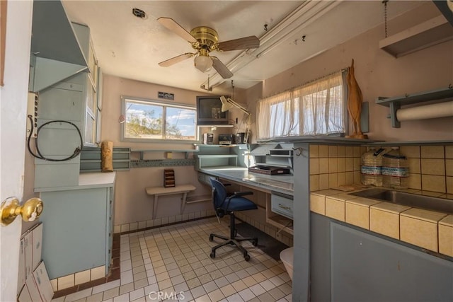 office space with ceiling fan, sink, and light tile patterned floors