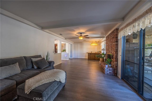 living room featuring ceiling fan, dark hardwood / wood-style floors, and beamed ceiling