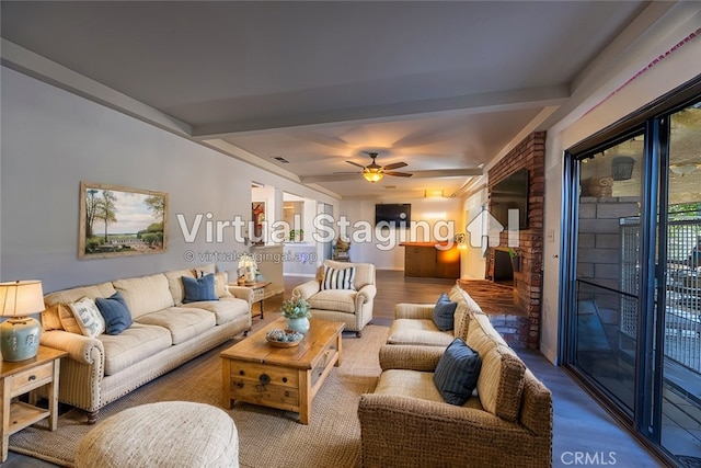 living room featuring ceiling fan, hardwood / wood-style floors, beam ceiling, and a fireplace