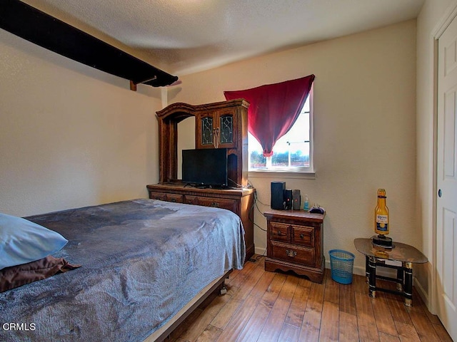 bedroom with hardwood / wood-style floors