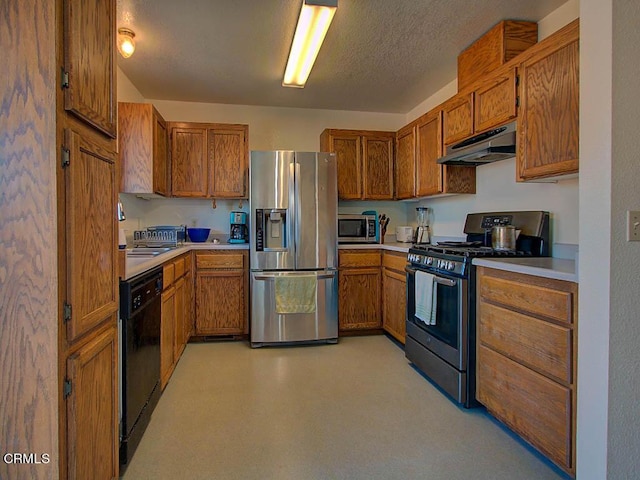 kitchen featuring a textured ceiling and appliances with stainless steel finishes