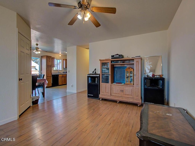 living room featuring ceiling fan and light hardwood / wood-style flooring