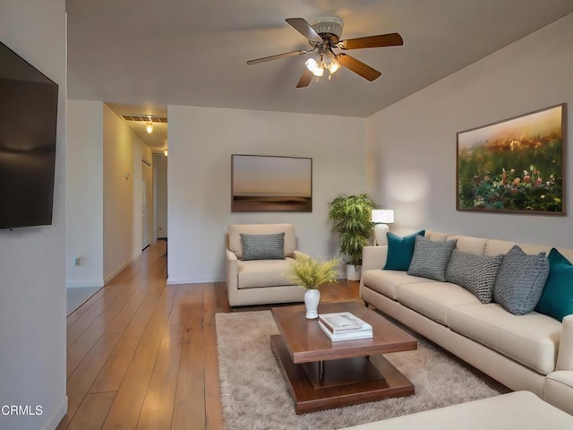 living room with ceiling fan and light wood-type flooring