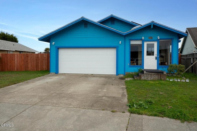 view of front of house with fence, an attached garage, a front lawn, and driveway