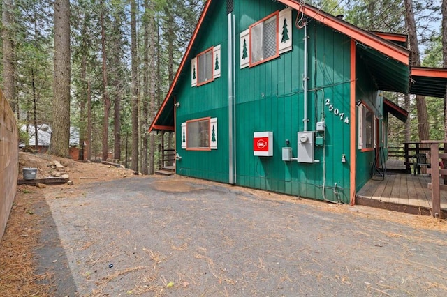 view of side of property with a wooden deck