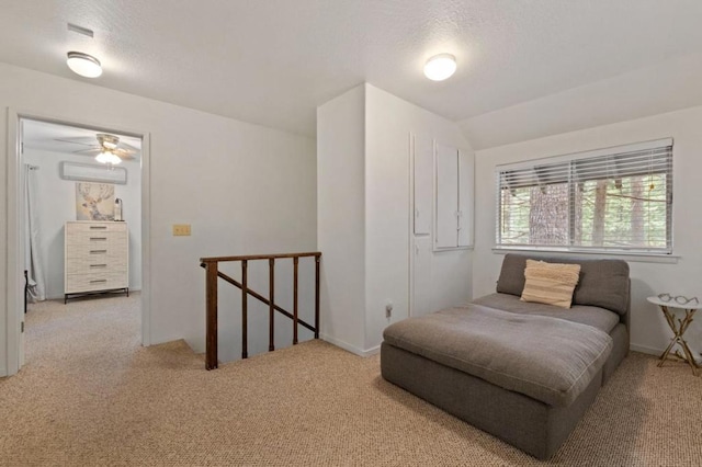 bedroom featuring light carpet and a textured ceiling