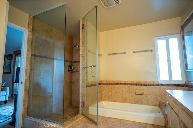 bathroom with tile walls, vanity, and separate shower and tub