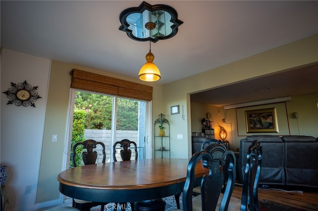 dining space with hardwood / wood-style flooring