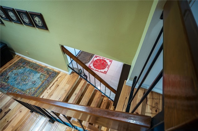 stairs with hardwood / wood-style floors