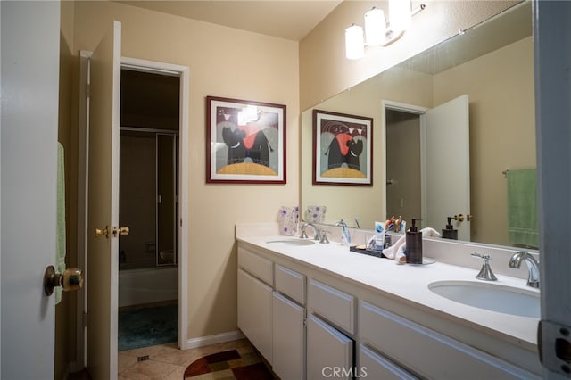 bathroom featuring shower / bath combination with glass door, tile patterned flooring, and vanity