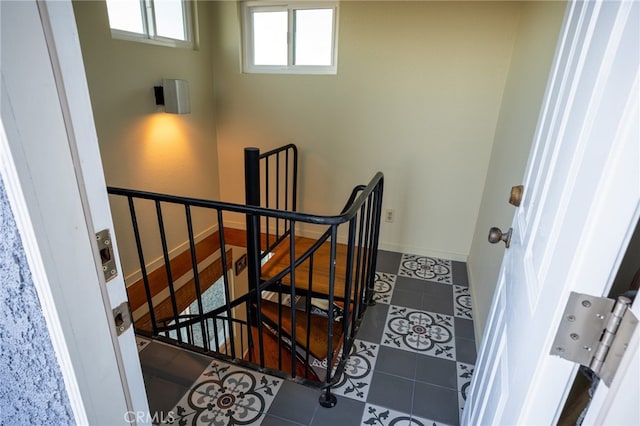 stairway with tile patterned flooring