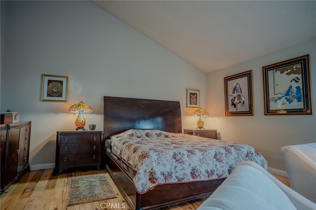 bedroom featuring light hardwood / wood-style flooring and vaulted ceiling