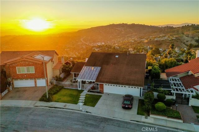 view of front of property with a yard, a garage, and a mountain view