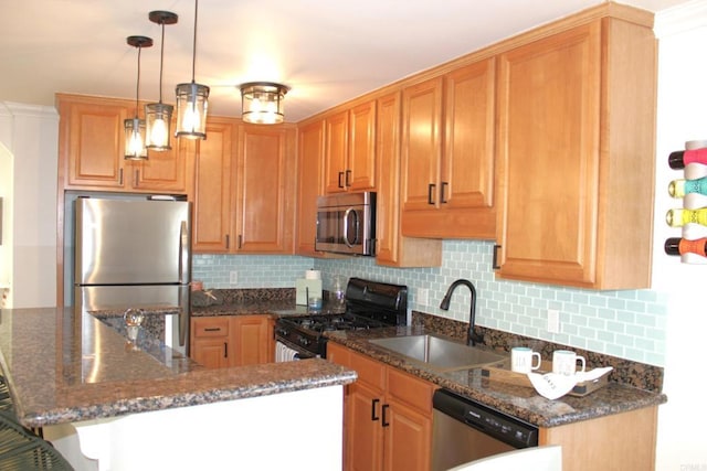 kitchen featuring sink, stainless steel appliances, backsplash, dark stone countertops, and pendant lighting